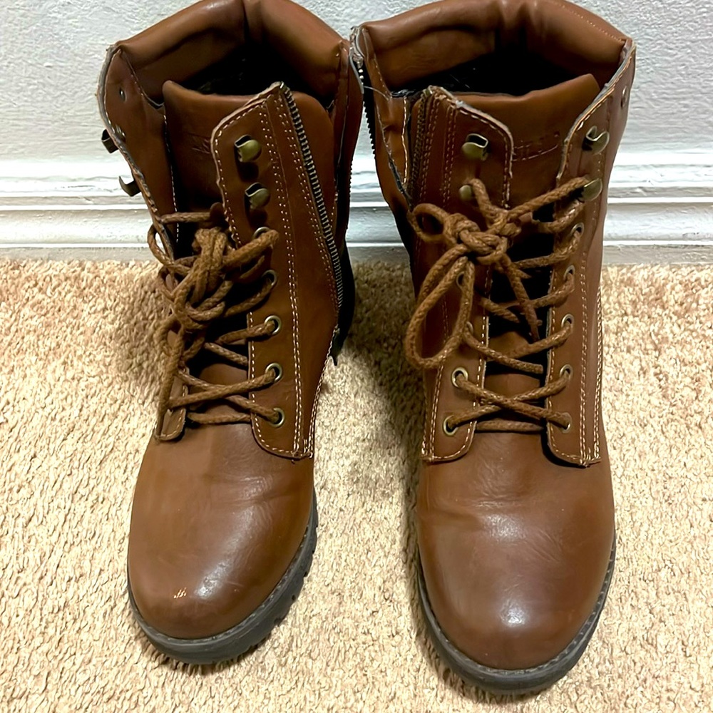 Brown laced and zippered heeled hiking boots